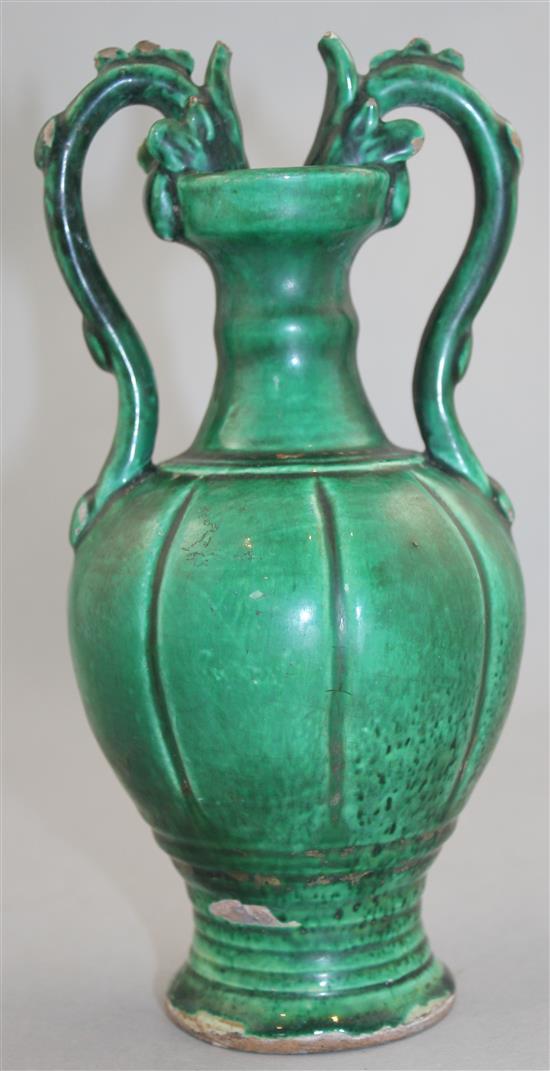 A Chinese green glazed pottery twin handled vase, in Tang style, 20.5cm.